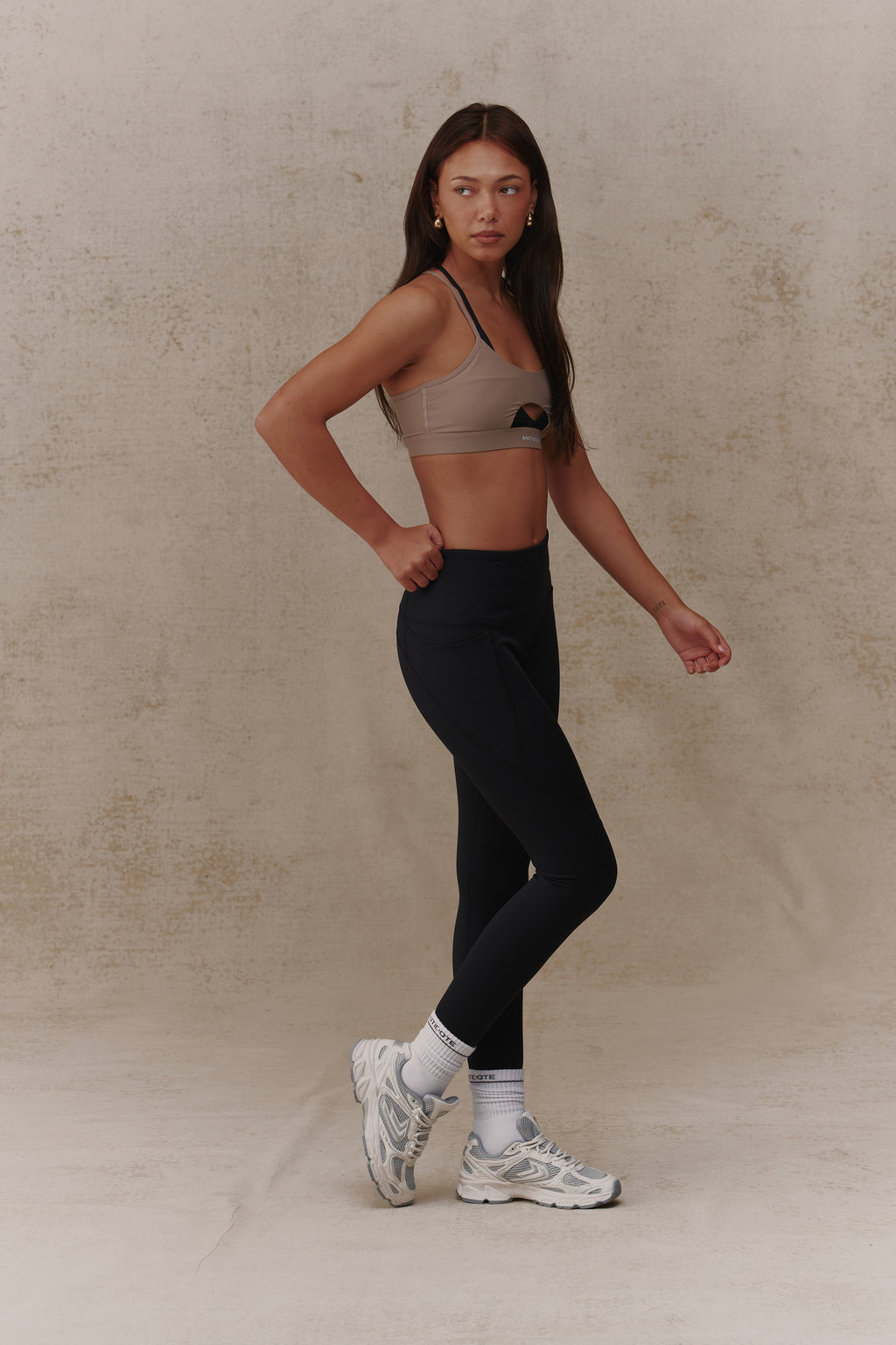 Woman wearing the Antidote Essential Leggings in Black Beauty, side view