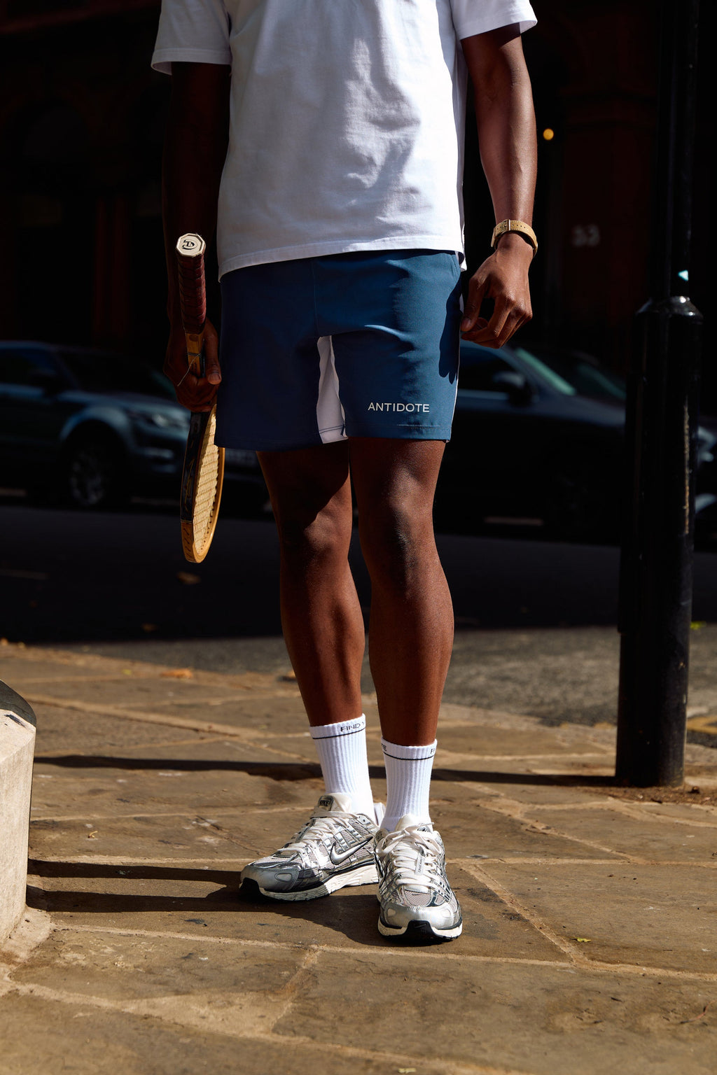 Man wearing the find your antidote Essential Socks with running trainers