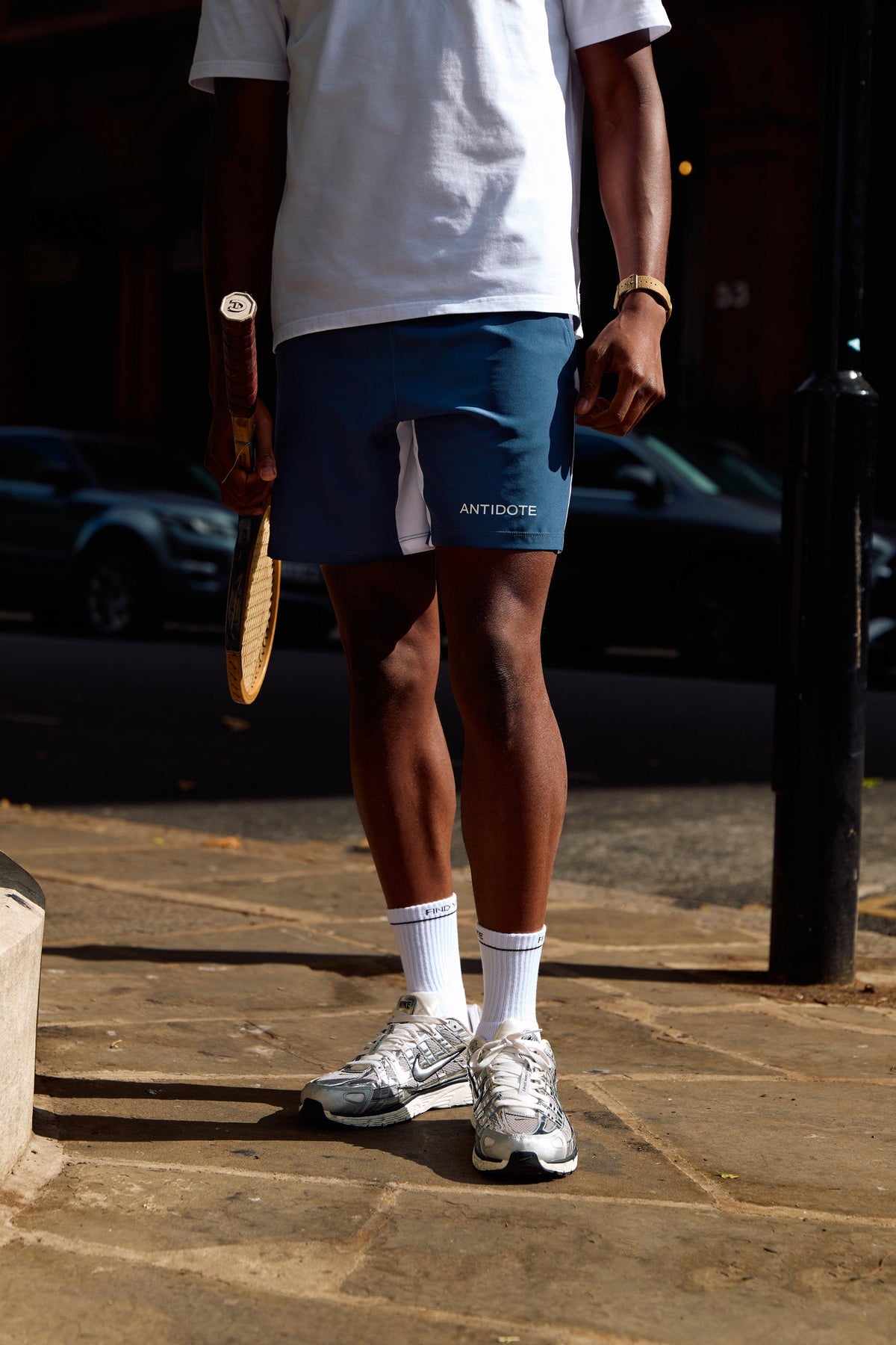 Man wearing the find your antidote Essential Socks with running trainers