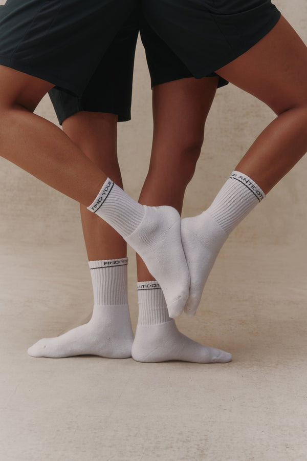 Two people wearing the find your antidote Essential Socks in White