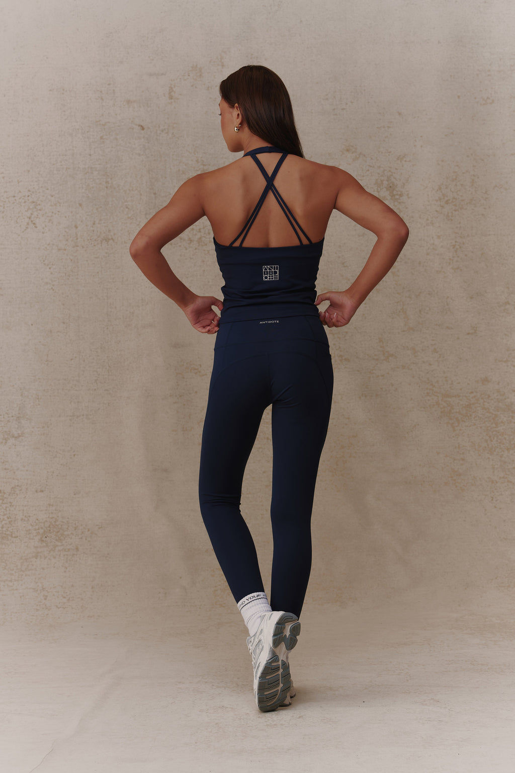 Woman wearing the Antidote Essential Leggings in Deep Ocean, back view