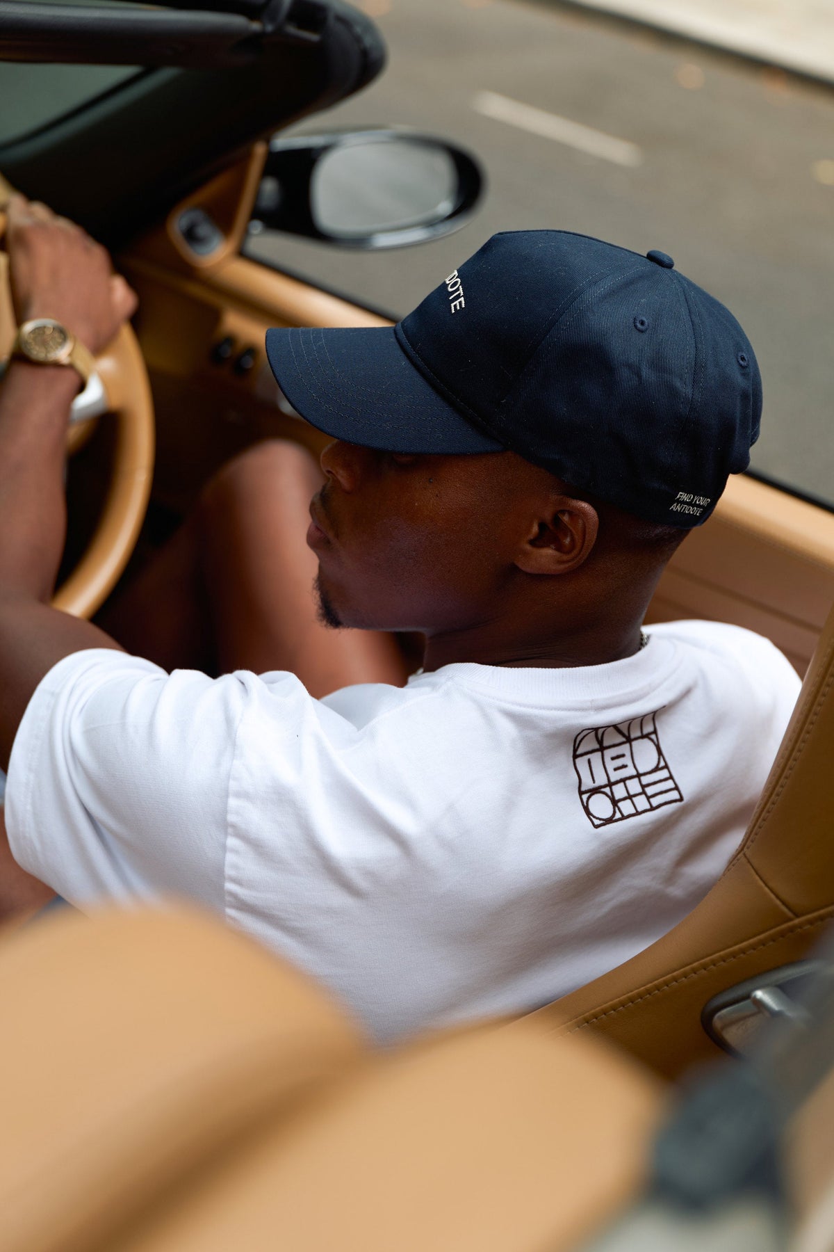 Antidote logo on the sleeve of the Logo Accompanied Reset Tee in Crisp White