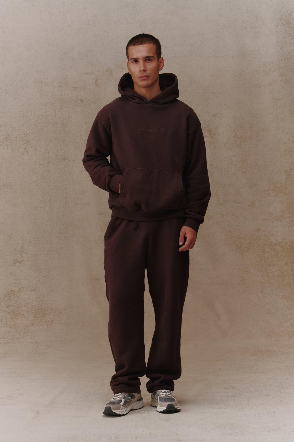 Man wearing the Antidote Recovery Hoodie in Ganache, front view
