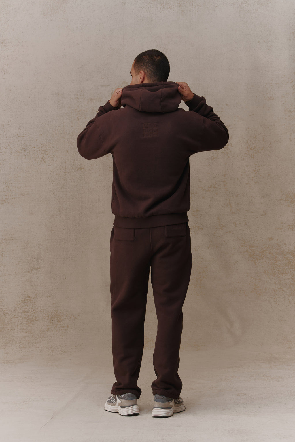 Man wearing the Antidote Men's Restore Joggers in Ganache, back view