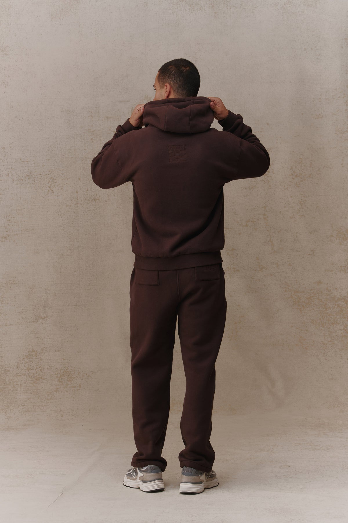 Man wearing the Antidote Men's Restore Joggers in Ganache, back view