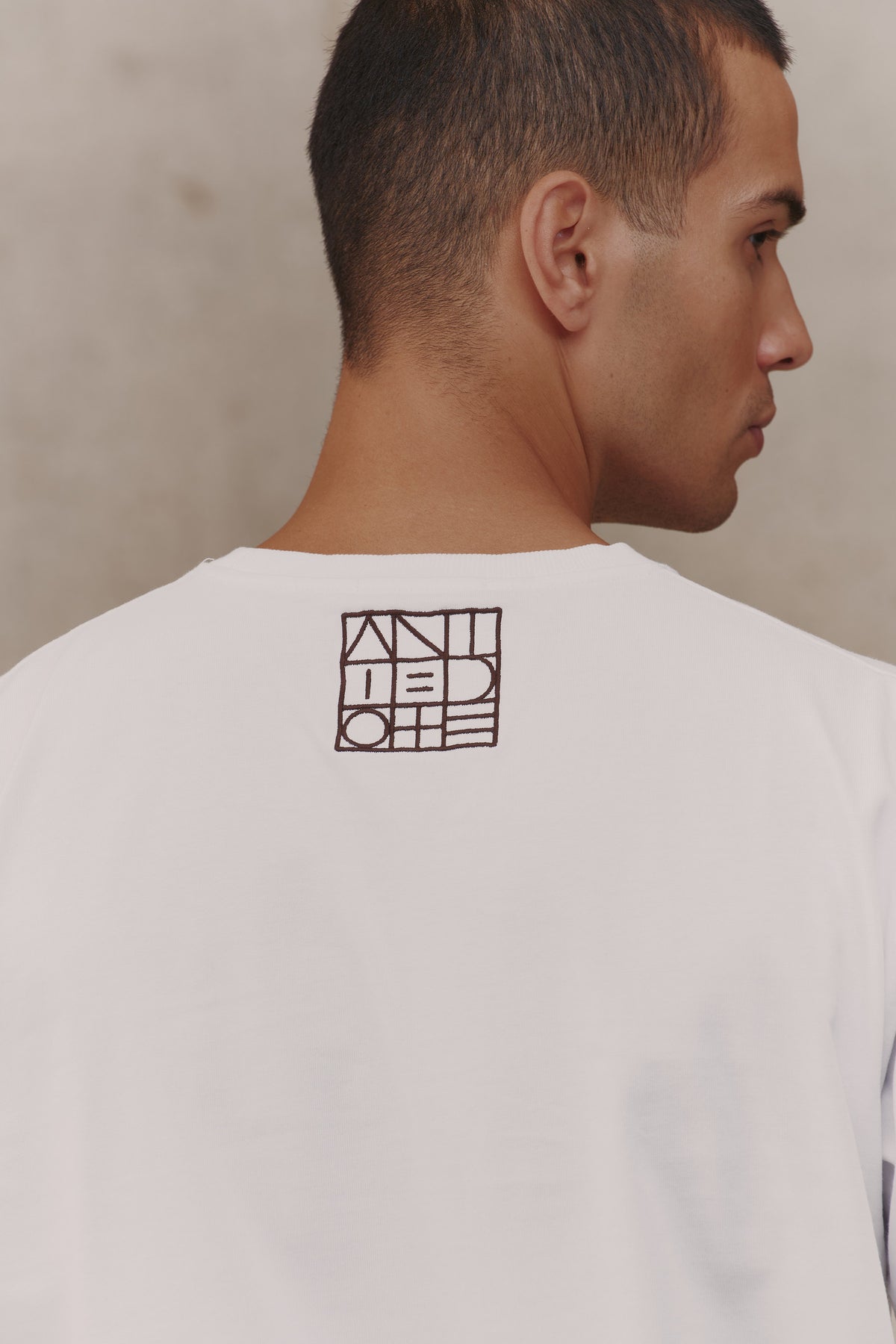 Embroidered logo on the back of the Reset Tee