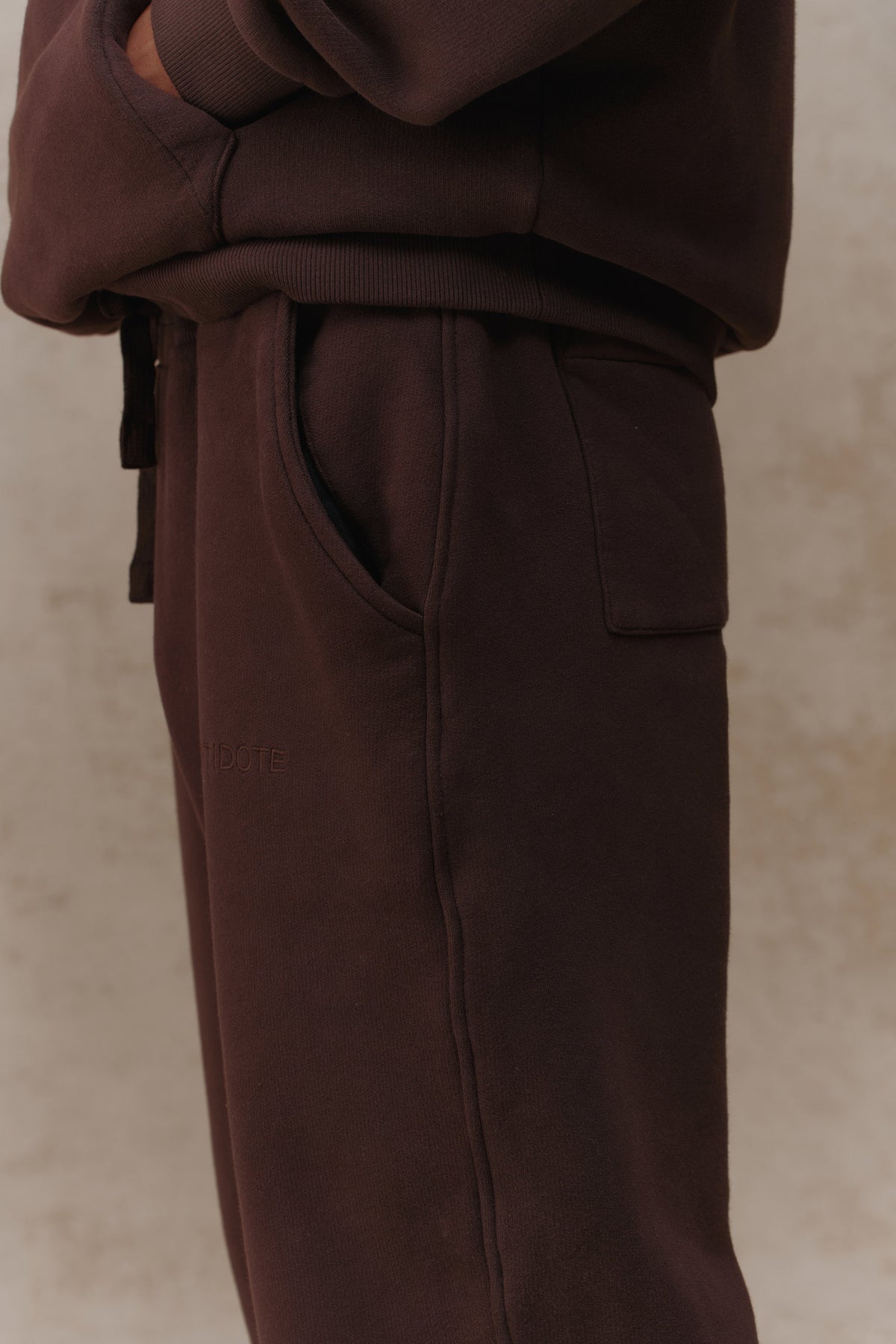 Man wearing the Antidote Men's Restore Joggers in Ganache, side view close-up