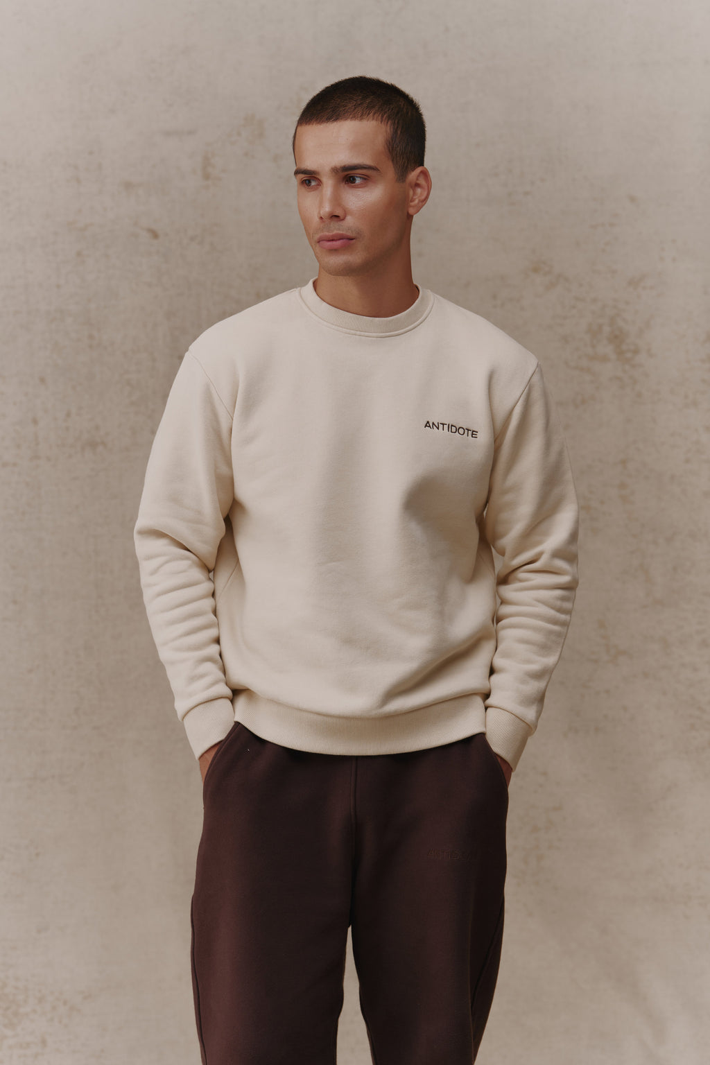 Man wearing the Antidote Revive Sweatshirt in Sand, front view