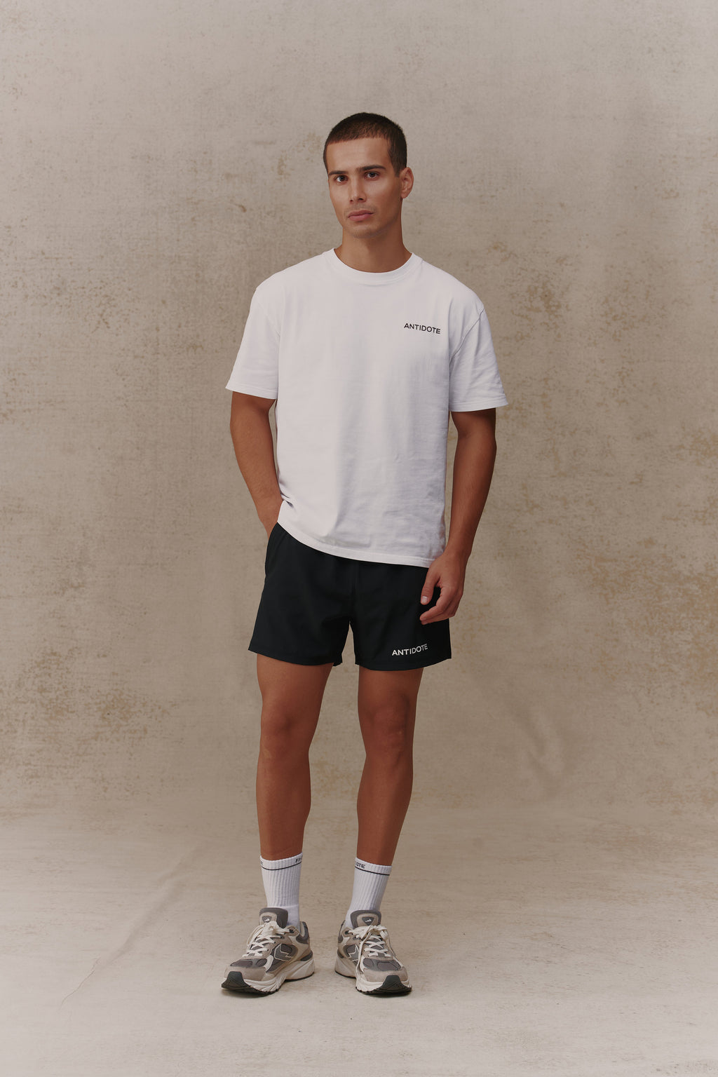 Man wearing the Antidote Motion Men's Shorts in Noir, front view