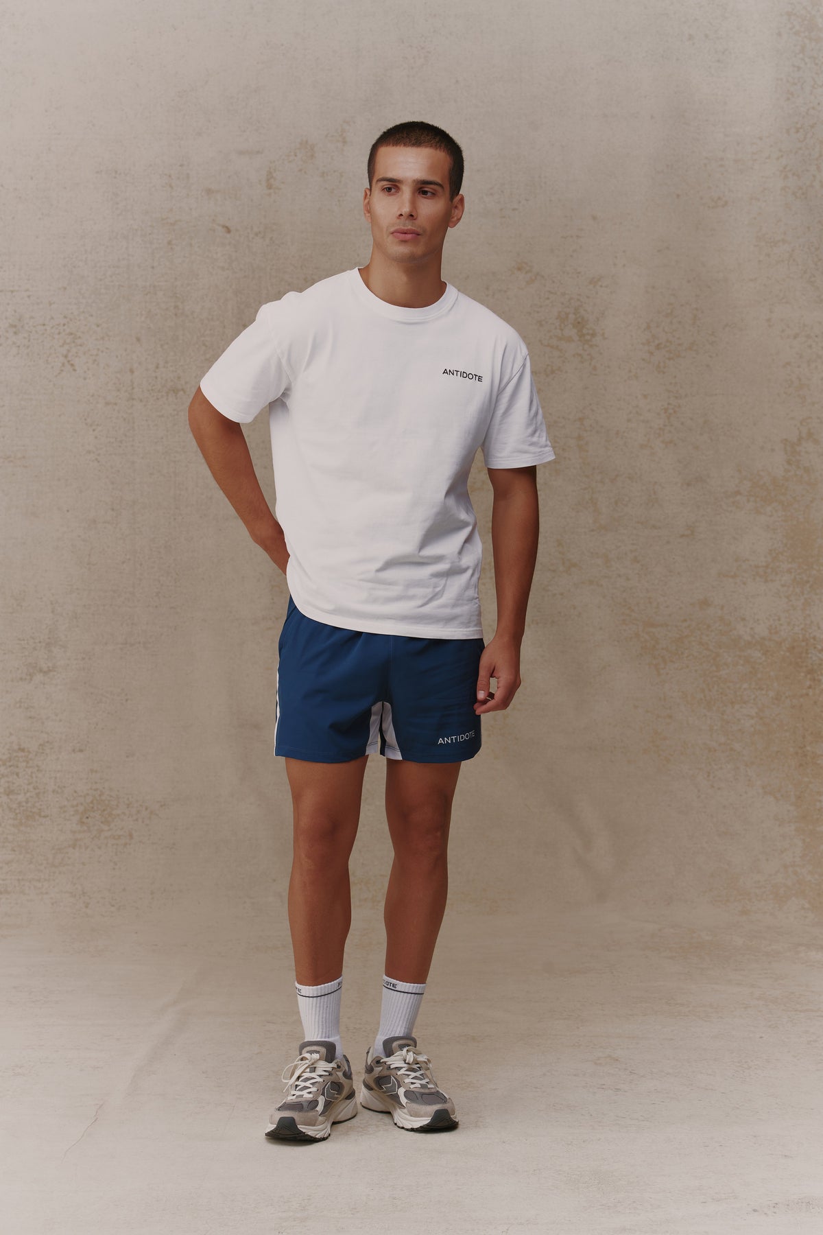 Man wearing the Antidote Motion Men's Shorts in Ocean Blue, front view