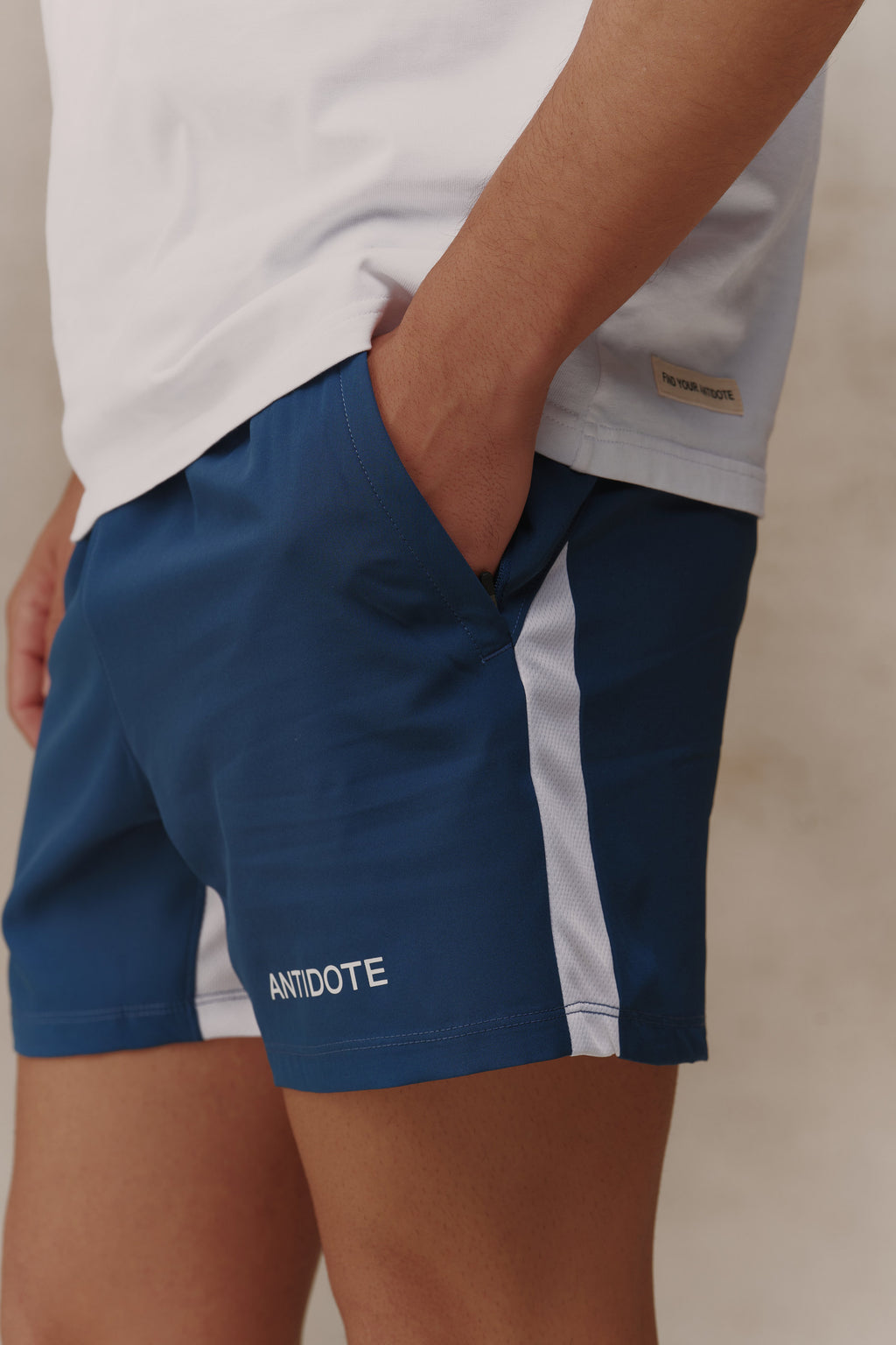 Man wearing the Antidote Motion Men's Shorts in Ocean Blue, close-up of the pocket