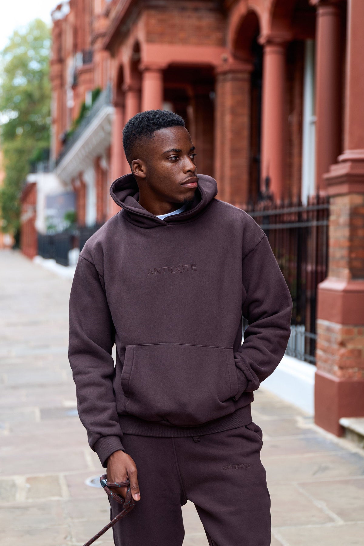 Man wearing the Antidote Recovery Hoodie in Gnanche, walking a London street