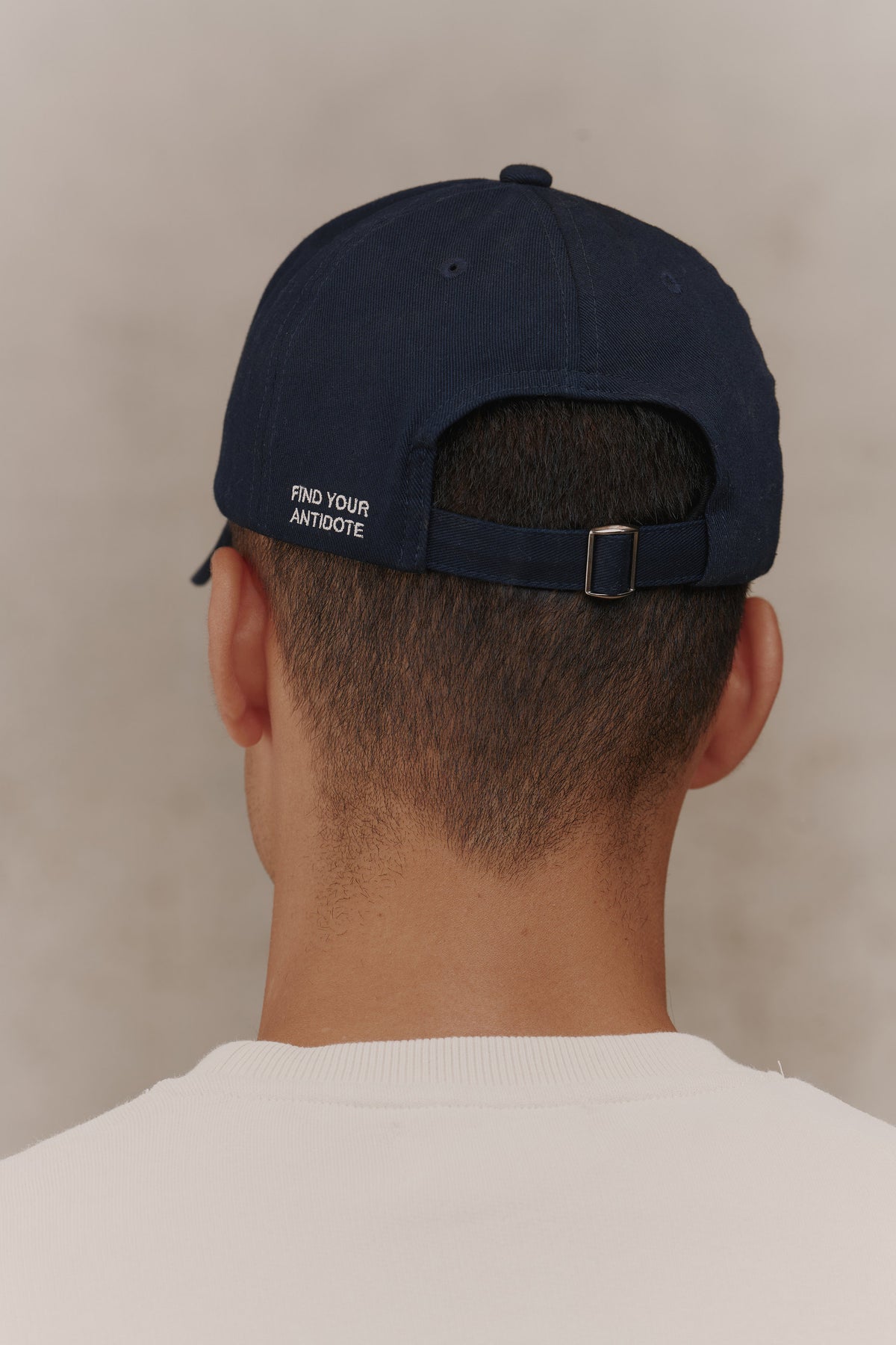 Silver buckle on the strap of The Original Antidote Cap