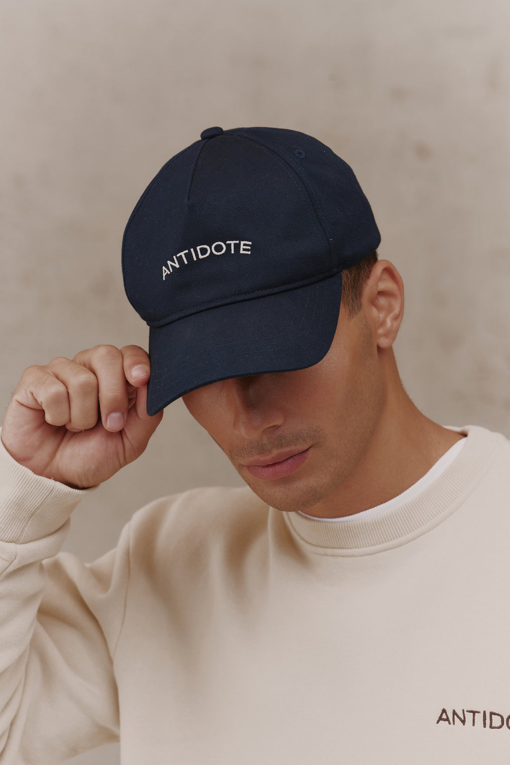 Man adjusting The Original Antidote Cap in Deep Navy