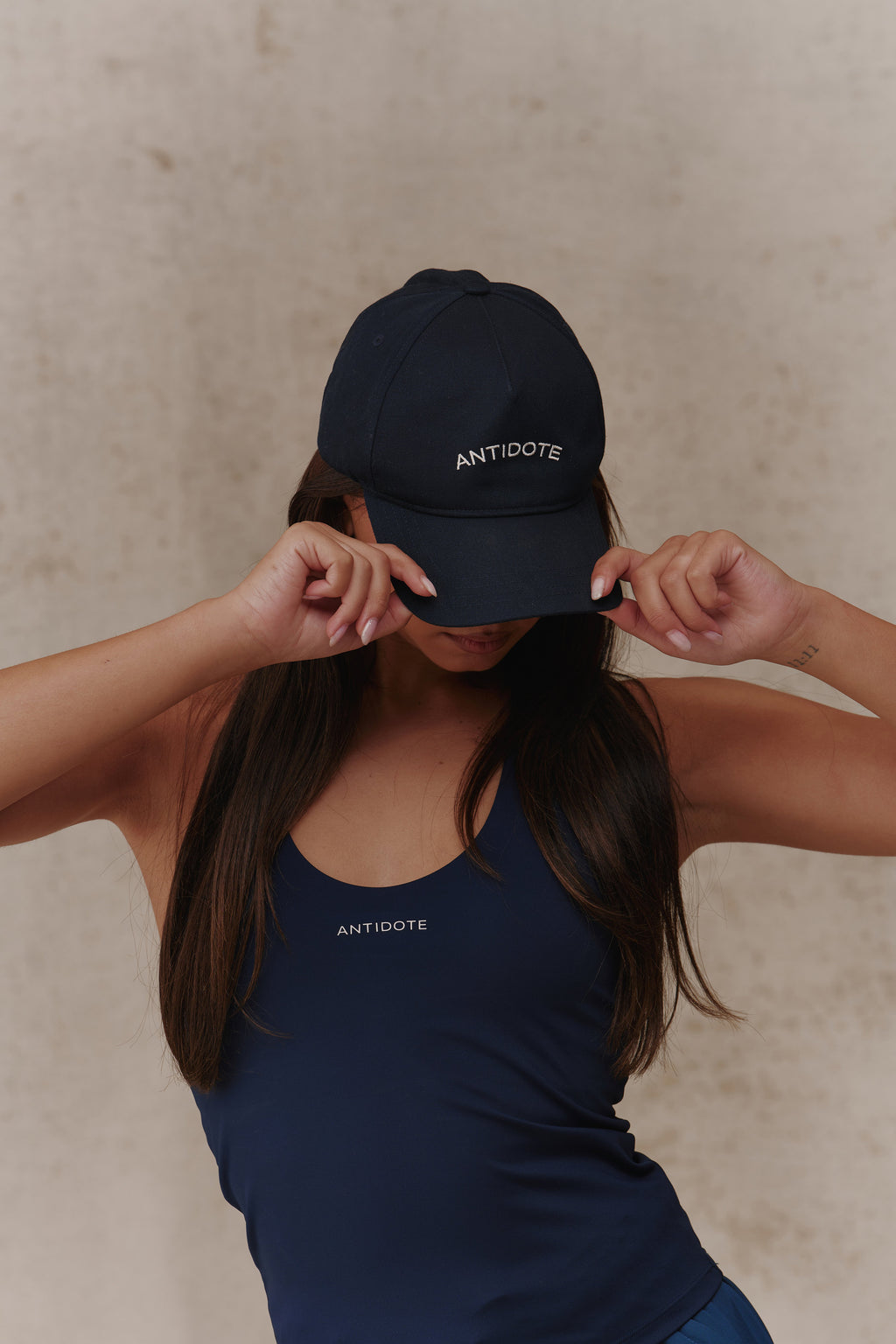 Woman wearing The Original Antidote Cap in Deep Navy, front view