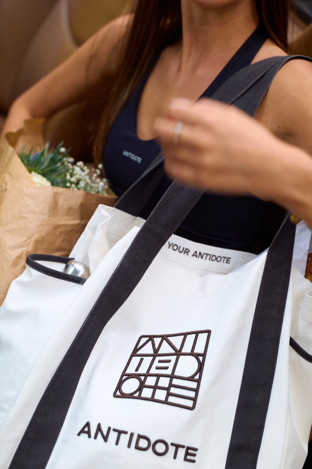 Woman carrying the Antidote Two Tone Tote in Ocean Blue