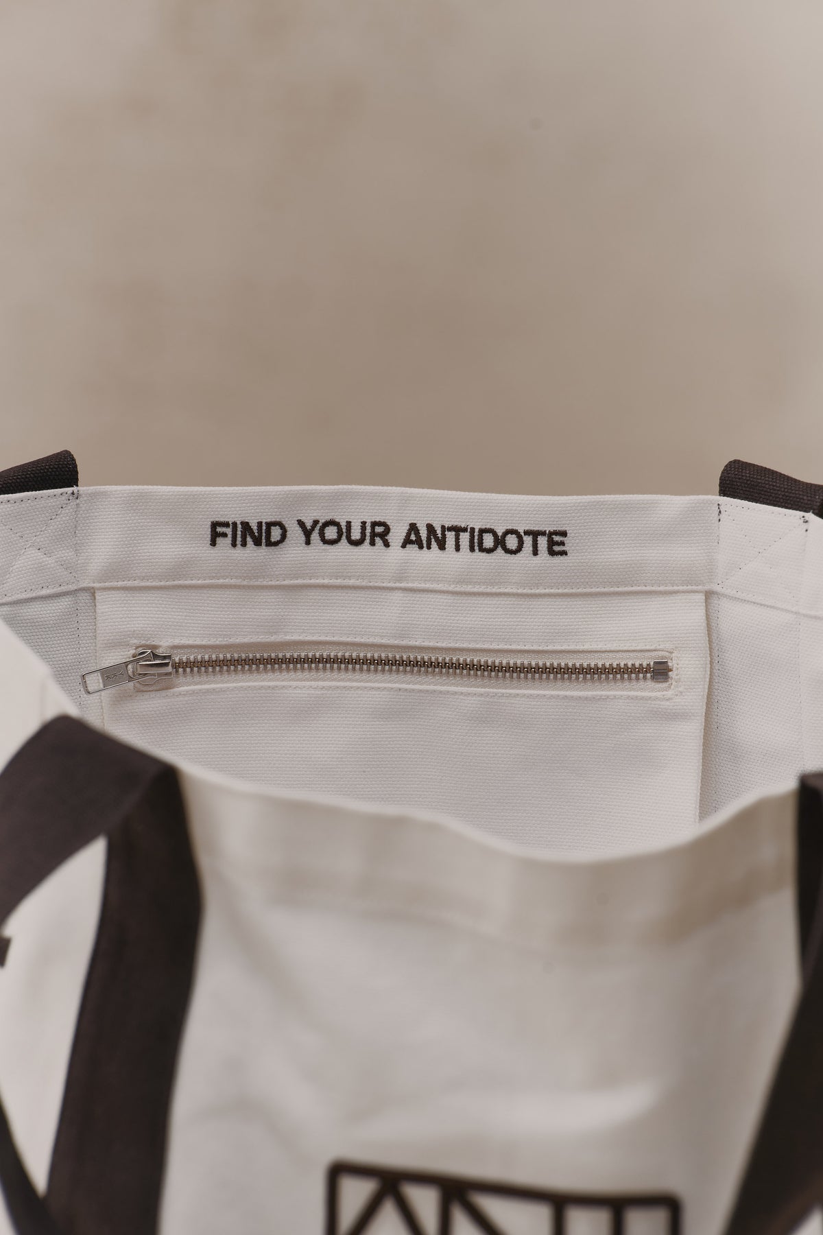 Internal zip pocket of the Antidote Two Tone Tote in Charcoal