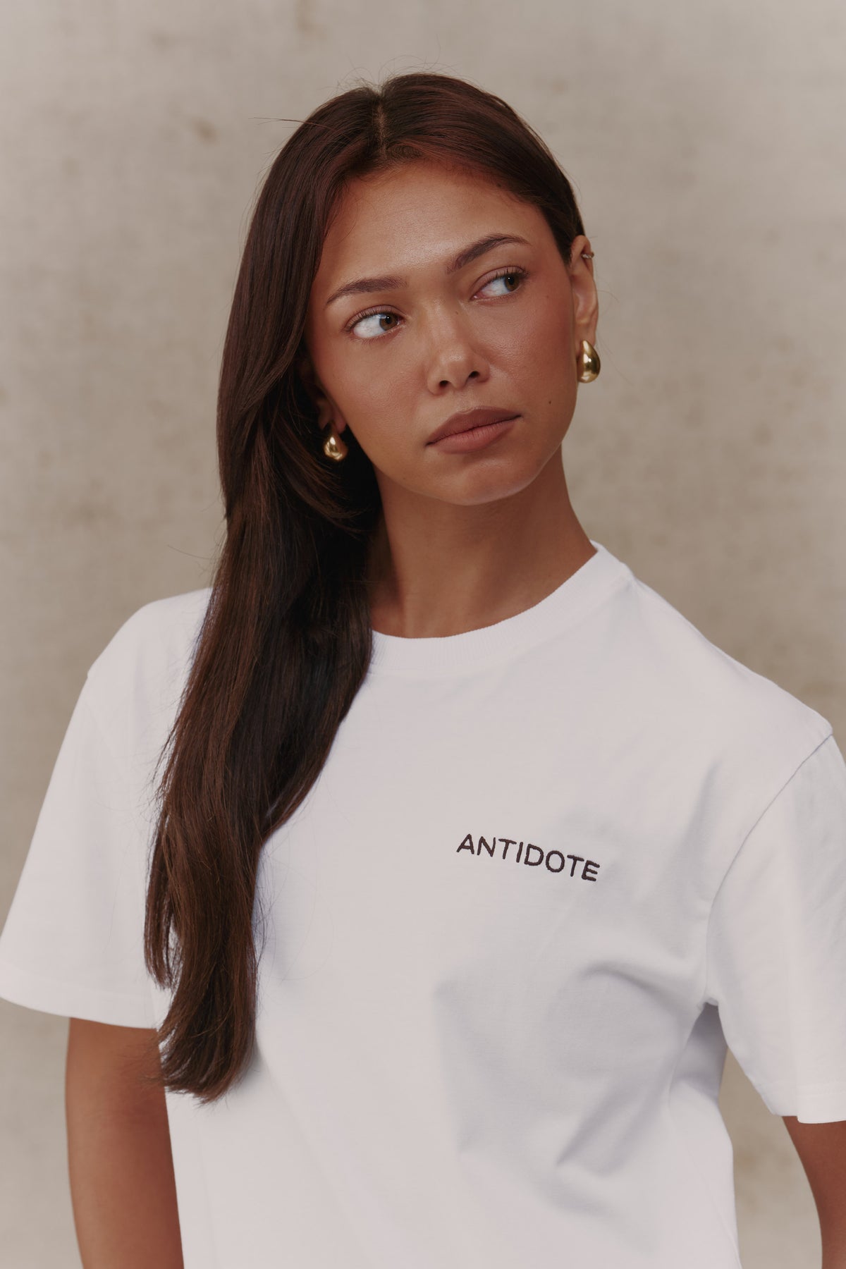 Woman wearing the Antidote Reset Tee in Crisp White, close-up front view