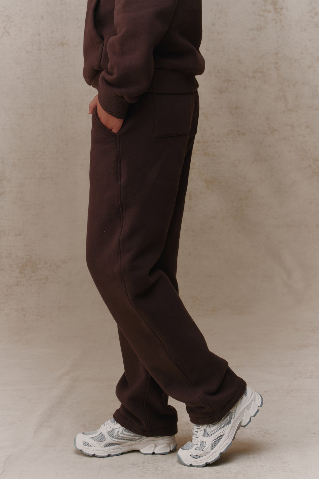 Woman wearing the Antidote Women's Restore Joggers in Ganache, side view