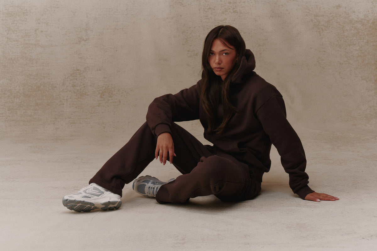 Woman wearing the Antidote Women's Restore Joggers in Gnanche, seated
