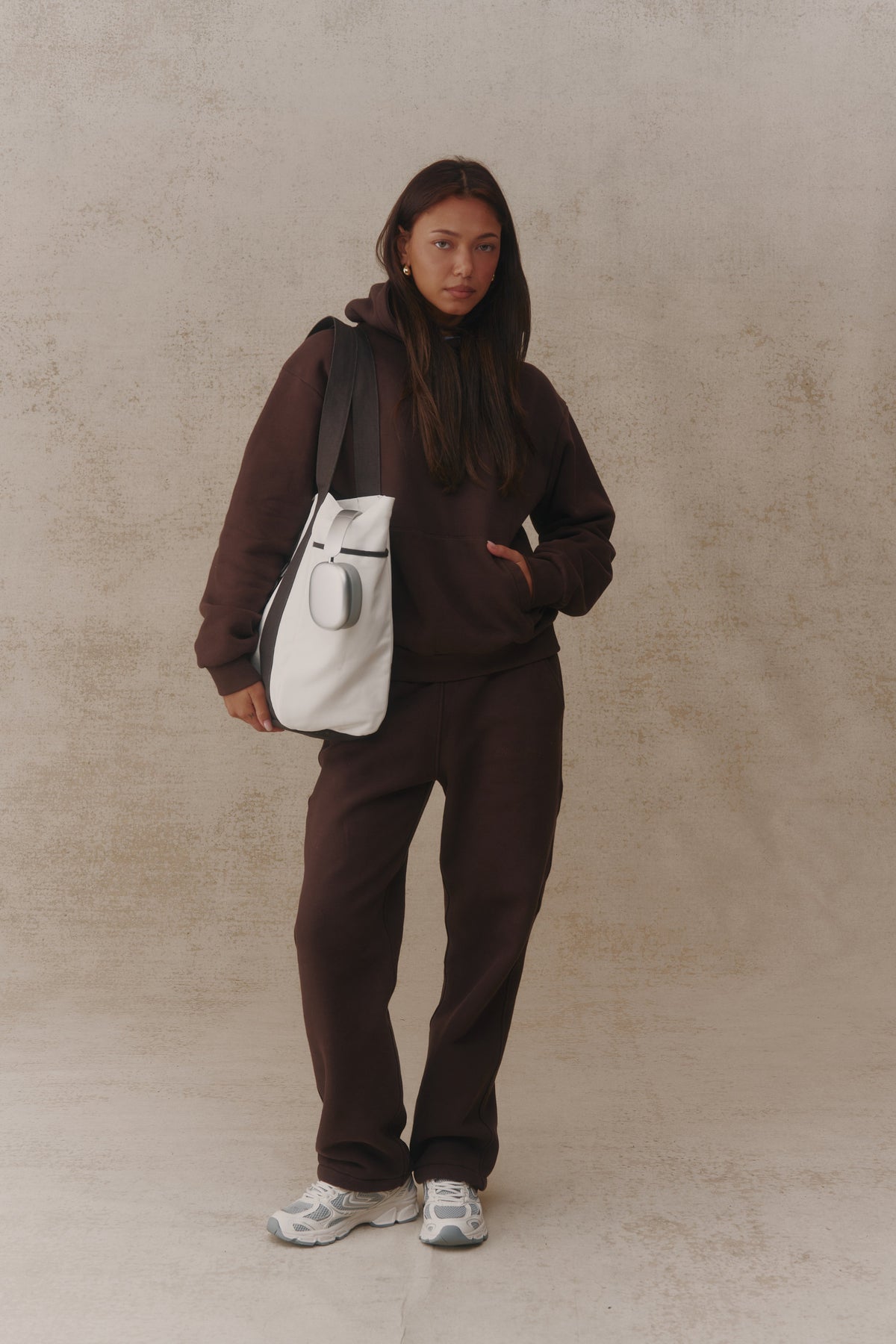 Woman wearing the Antidote Women's Restore Joggers in Ganache, carrying the Two Tone Tote